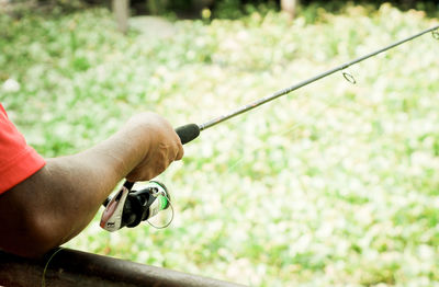 Close-up of man holding fishing rod