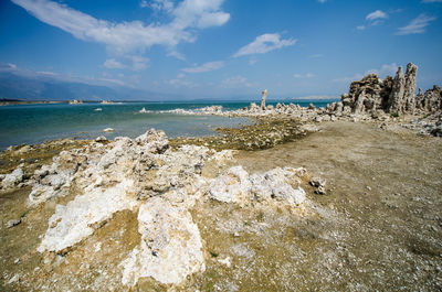 Rocks on beach against sky