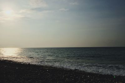 Scenic view of beach against sky during sunset