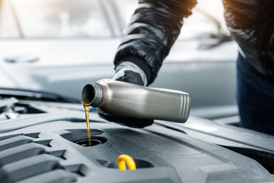 Cropped hand of man repairing car