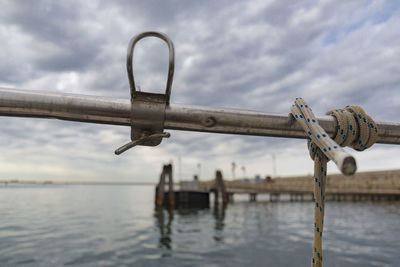 Close-up of rope against sea against sky