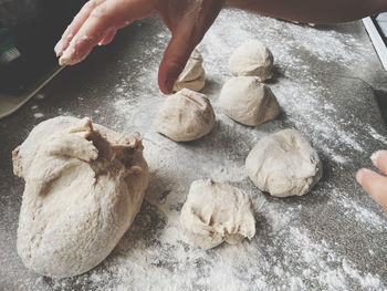 Portions of dough on a kitchen workbench 