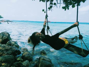 Girl swinging at beach