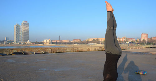 Practicing yoga facing the sea at dawn