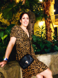 Portrait of smiling young woman sitting outdoors