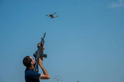 Low angle view of man standing against sky