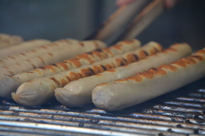 Close-up of sausages cooking on grill