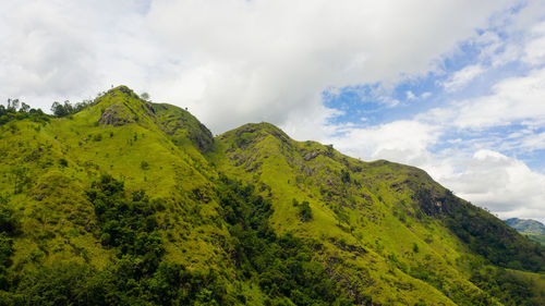 Aerial drone of mountain landscape with mountain peaks covered with forest.  