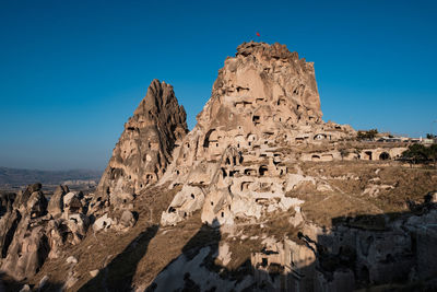 Low angle view of rock formations against sky