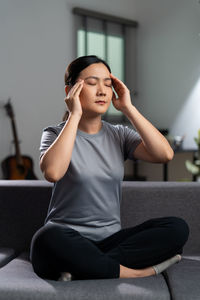 Portrait of young woman sitting at gym