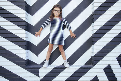 Portrait of young woman standing on tiled floor