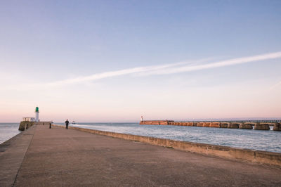 The small jetty and the green lighthouse in les sables d'olonne