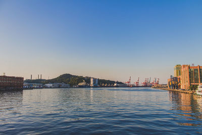 Boats in river with buildings in background