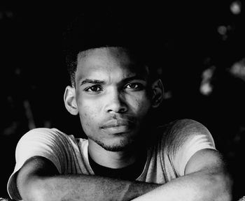 Portrait of young serious man looking at camera