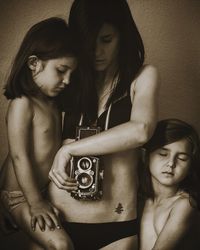 Young woman with children and camera. 