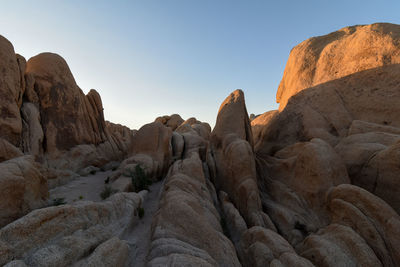 Low angle view of rock formation against sky