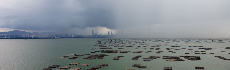 Panoramic view of beach against cloudy sky