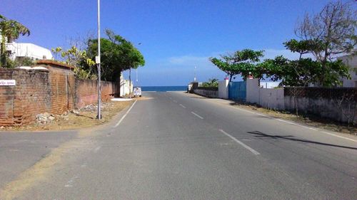 Empty road against blue sky