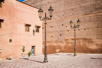 Street light on wall by building