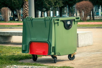 Garbage can on footpath at park