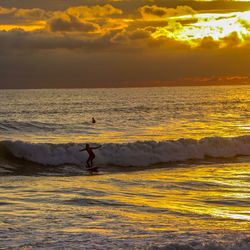 Woman doing surfing in the beautiful evening