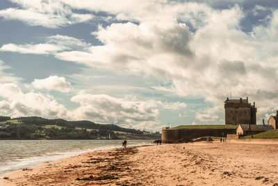 Scenic view of beach by sea against sky