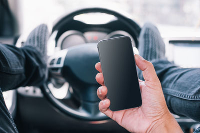 Close-up of hand holding mobile phone