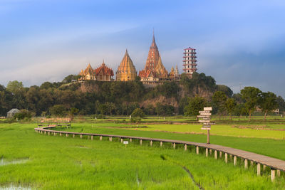 View of temple on field against sky