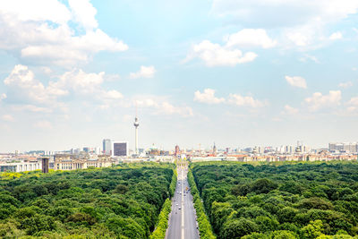 Aerial view of forest in city against sky