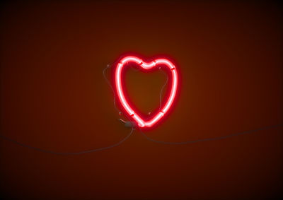 Close-up of red heart shape against black background