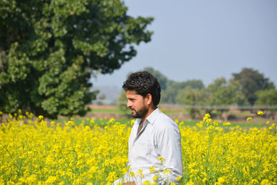 Young man standing in field