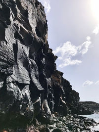 Low angle view of rock formation against sky