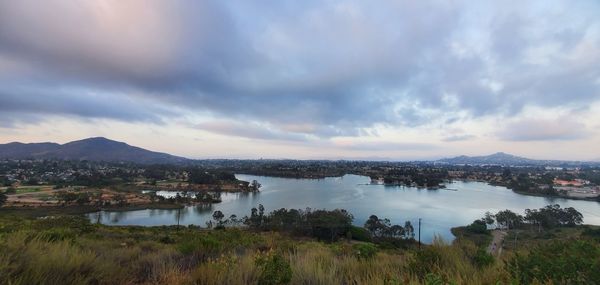 Panoramic view of lake by city against sky