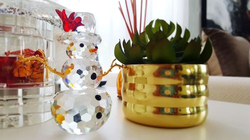 Close-up of decoration with potted plant on table