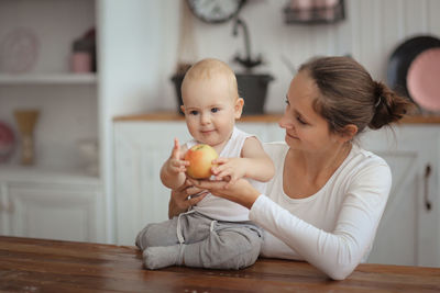 Portrait of cute girl playing with toy at home