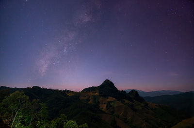 Scenic view of mountains against sky at night