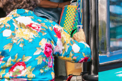 Midsection of woman with multi colored store for sale