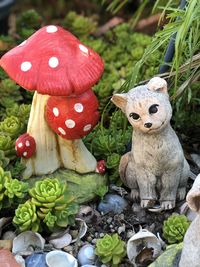 Close-up of figurine with mushrooms