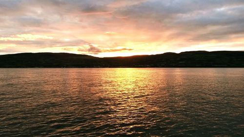 Scenic view of lake at sunset