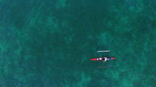 High angle view of people floating on sea