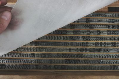 Cropped hand holding typewriter