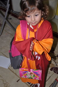 High angle view of cute girl standing with school bag