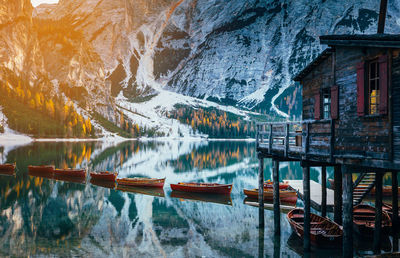 Scenic view of lake by buildings against mountain