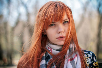 Close-up portrait of young woman standing outdoors