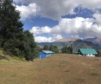 Houses on field against sky