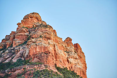 Low angle view of rock formations against clear sky