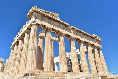 Low angle view of historical building against blue sky