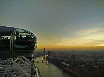 Millennium wheel in city during sunset