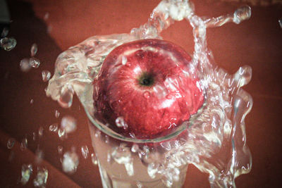 Close-up of apple on glass table