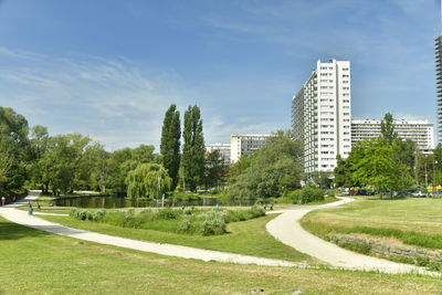 View of park and buildings against sky